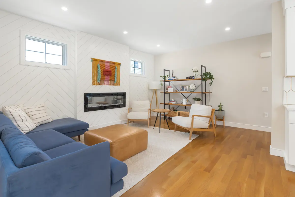The living room, open to the kitchen and dining area