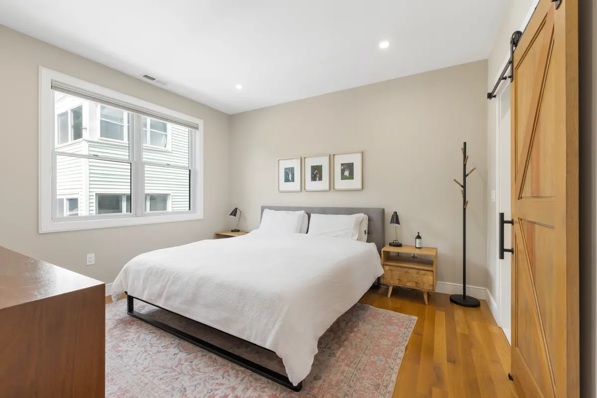 The primary bedroom, with a walk-in closet behind the barn door