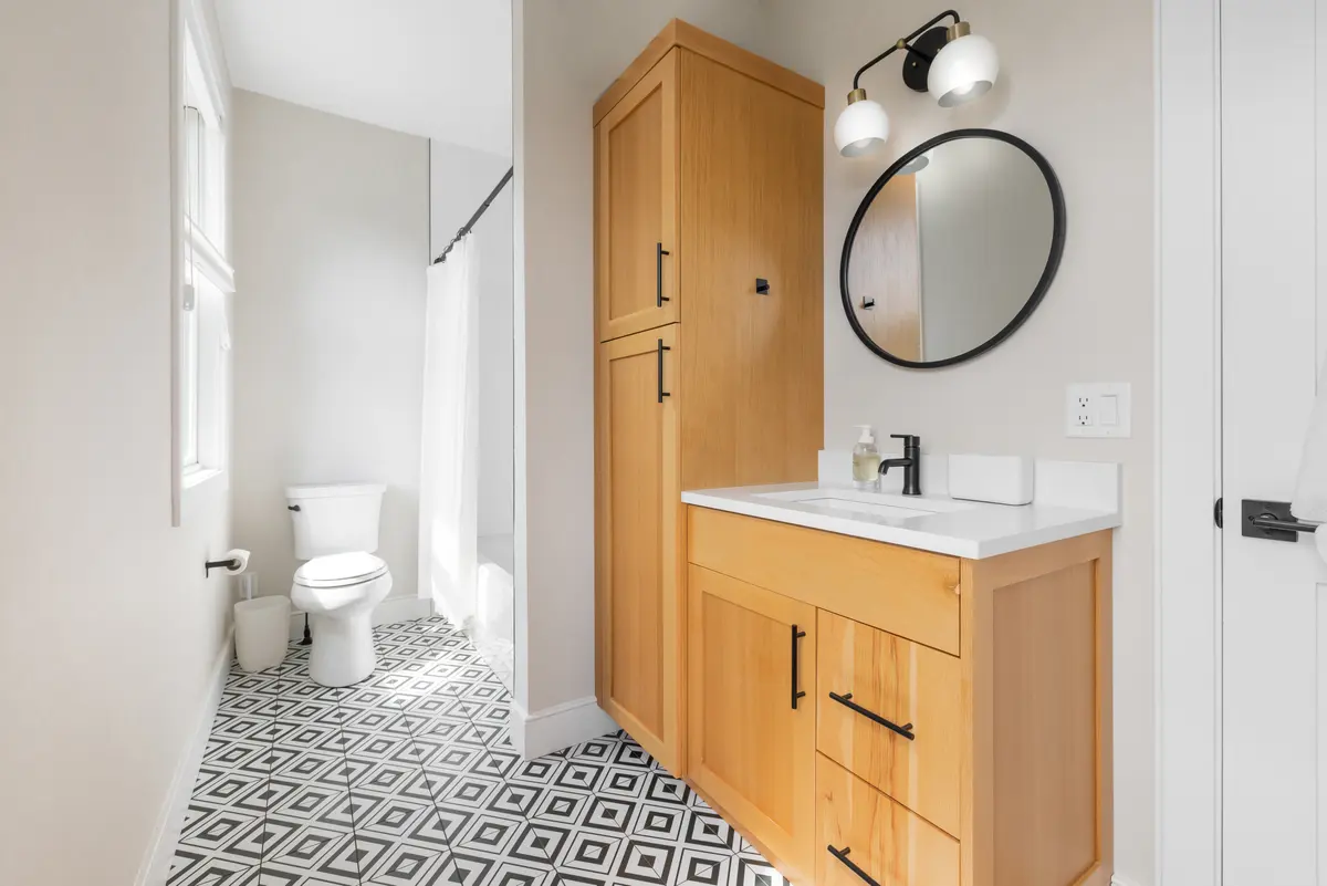 Second-floor bath, with a patterned tile floor and tub