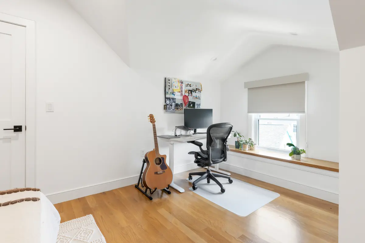 A desk area built into the top-floor bedroom's window wall