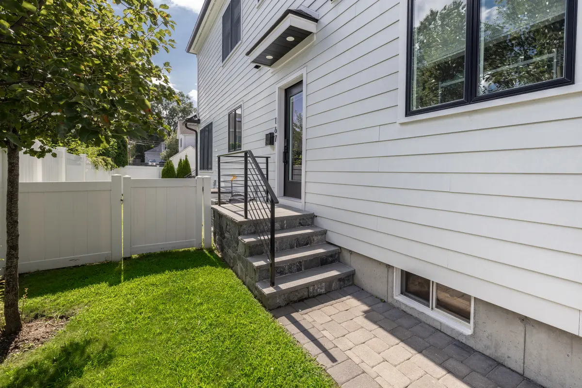 The fenced side yard and steps up to the deck